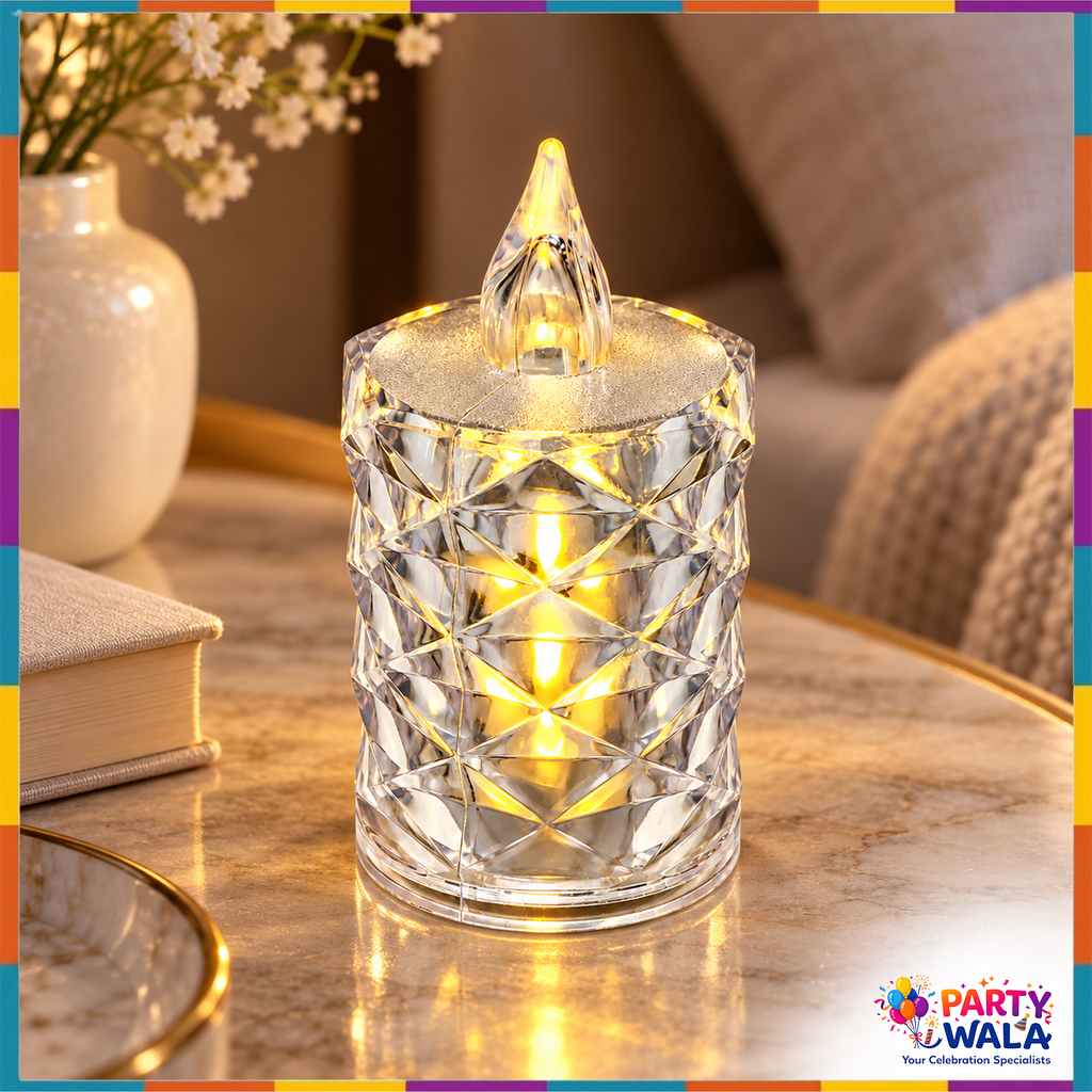 Crystal-style flameless candle light glowing on a table beside a book and vase