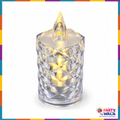 Single crystal-style flameless candle light with faceted clear body and warm glow