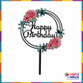 Black circular Happy Birthday cake topper with pink flowers and blue-green leaves