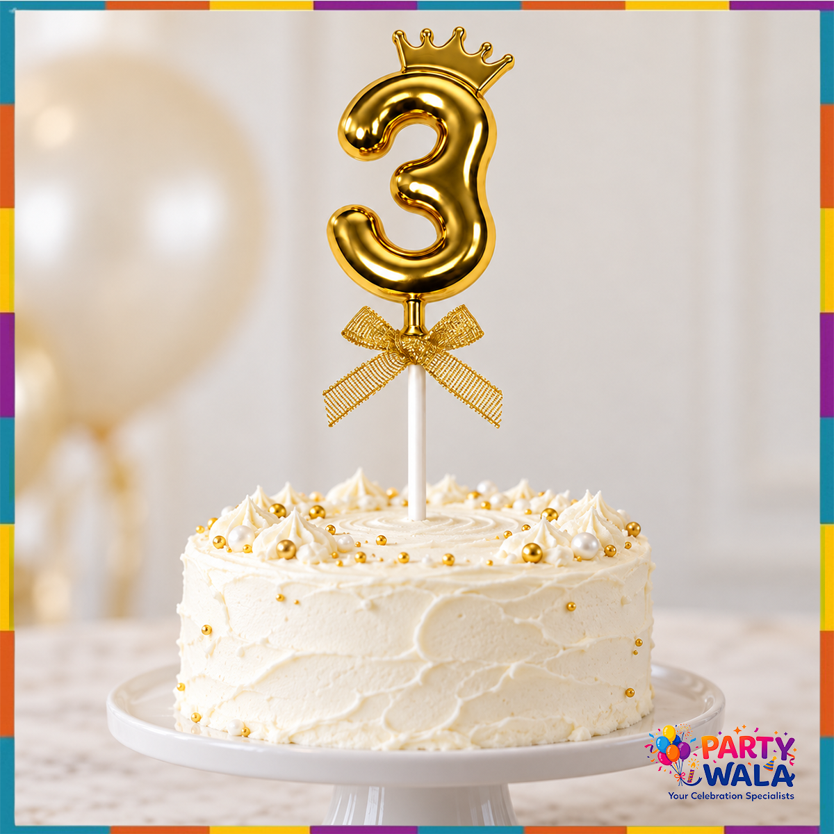 Gold crown number 3 cake topper with bow displayed on a white birthday cake