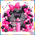 Pink and black balloon garlands with a large polka dot bow in a styled birthday display
