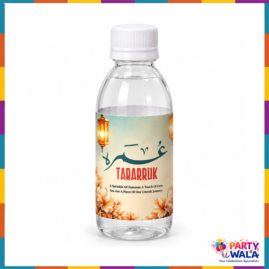 Umrah Tabarruk bottle with teal Arabic calligraphy, peach flowers and warm gold lanterns